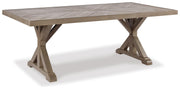 Ashley Furniture Beachcroft outdoor dining set with round table and six chairs, made of weather-resistant material.