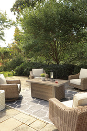 Outdoor seating set with Ashley Furniture Beachcroft fire pit table and four Nuvella swivel lounge chairs in a patio setting.