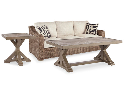 Ashley Furniture Beachcroft outdoor table set with Nuvella sofa, coffee table, and end table for stylish outdoor living.