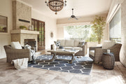 Ashley Furniture Beachcroft outdoor conversation set with cushioned chairs and table, perfect for patio relaxation.