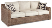 Ashley Furniture Beachcroft outdoor seating set with cushioned chairs and a table, ideal for patio or garden relaxation.