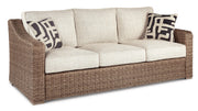 Ashley Furniture Beachcroft outdoor seating set with cushioned chairs and table, perfect for patio relaxation.