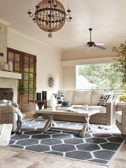Outdoor Ashley Furniture Beachcroft outdoor conversation set with cushioned seats and coffee table, perfect for relaxing outside.