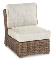 Outdoor Ashley Furniture Beachcroft outdoor seating set with cushioned chairs and table, perfect for patio relaxation.