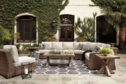 Outdoor Ashley Furniture Beachcroft outdoor seating set with cushioned chairs and a matching table on a patio.