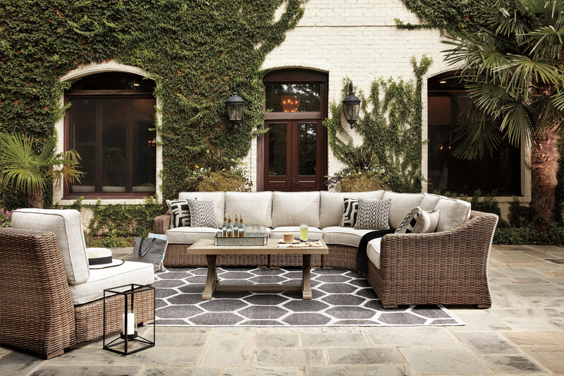 Ashley Furniture Beachcroft outdoor seating set with cushioned chairs and a matching table, designed for patio relaxation.