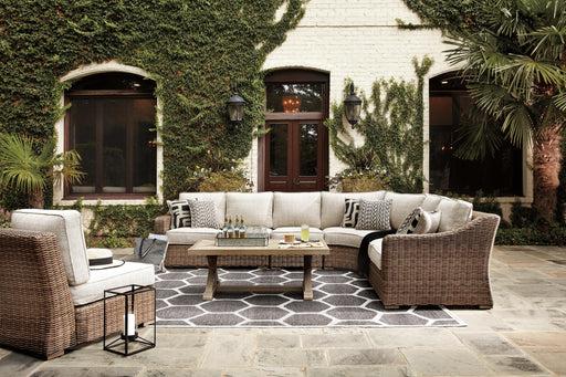 Ashley Furniture Beachcroft outdoor seating set with cushioned chairs and a matching table, designed for patio relaxation.
