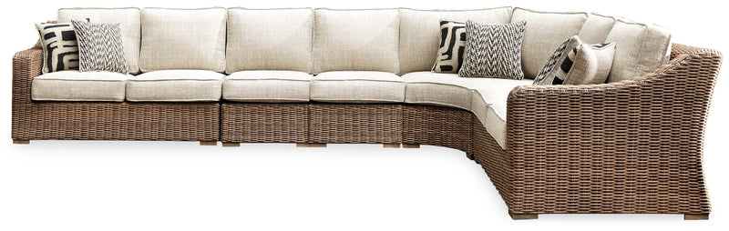 Ashley Furniture Beachcroft outdoor seating set with cushioned chairs and a matching table, perfect for patio relaxation.