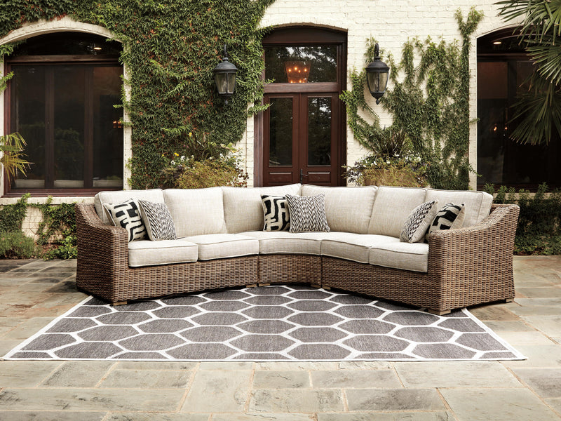 Ashley Furniture Beachcroft outdoor seating set with cushioned chairs and a matching table, ideal for patio relaxation.