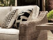 Ashley Furniture Beachcroft outdoor seating set with cushioned chairs and a glass-topped table for patio relaxation.