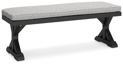 Ashley Furniture Beachcroft outdoor dining bench with cushion, showing a sturdy wooden frame and comfortable seating for outdoor use.