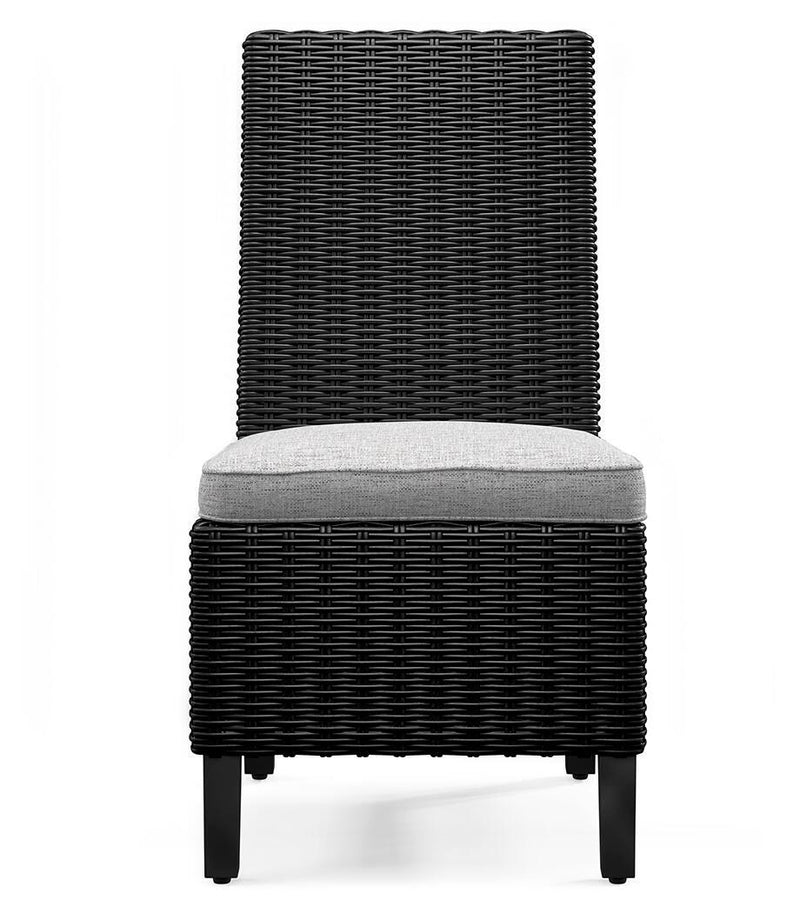 Set of two Ashley Furniture Beachcroft outdoor dining side chairs with cushions, featuring woven rattan design and sturdy metal frames.