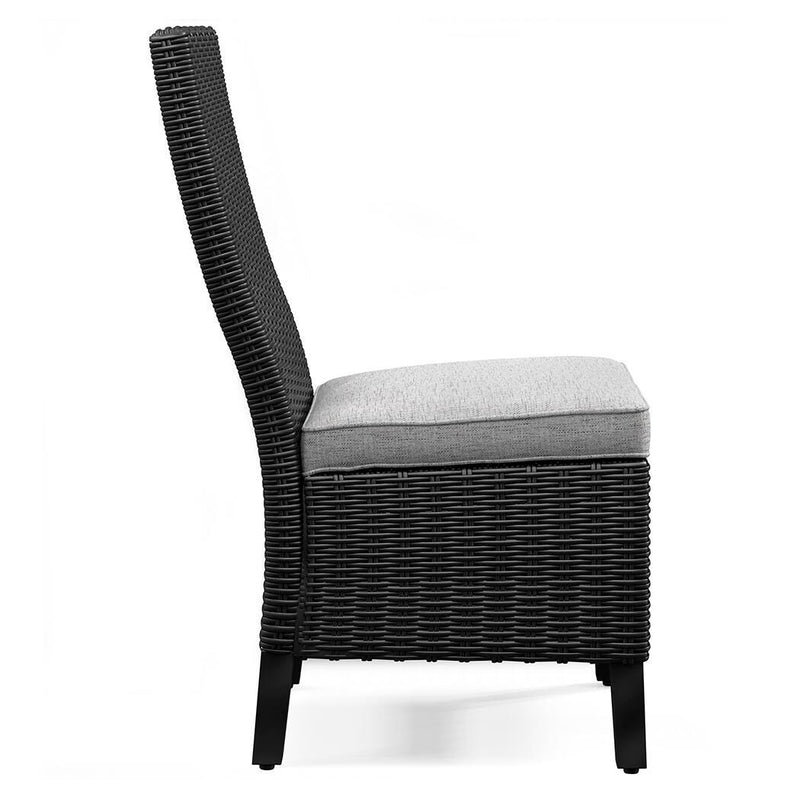 Set of two Ashley Furniture Beachcroft outdoor side dining chairs with cushions, featuring woven rattan design and metal frame.