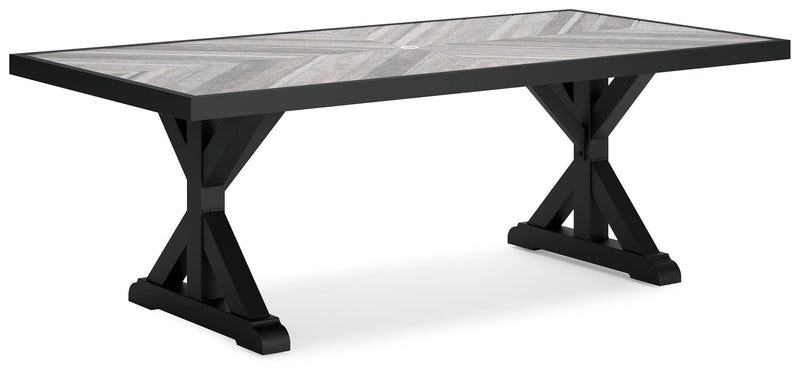 Ashley Furniture Beachcroft outdoor dining table shown from an angled view, featuring a rectangular tabletop and sturdy outdoor-ready design.