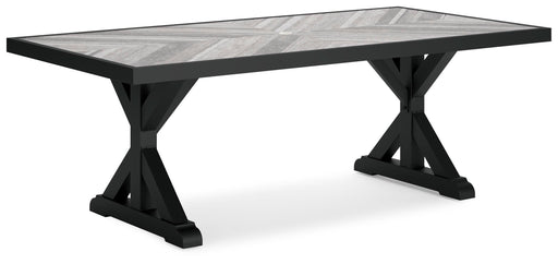 Ashley Furniture Beachcroft outdoor dining table shown from an angled view, featuring a rectangular tabletop and sturdy outdoor-ready design.