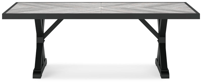 Outdoor Ashley Furniture Beachcroft outdoor dining table with wooden slats and sturdy metal frame on a patio setting.