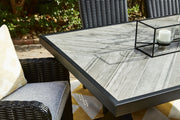 Ashley Furniture Beachcroft outdoor dining table with a slatted wooden top and sturdy metal legs for outdoor use.