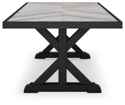 Ashley Furniture Beachcroft outdoor dining table with a wooden top and metal legs, ideal for patio or garden dining spaces.