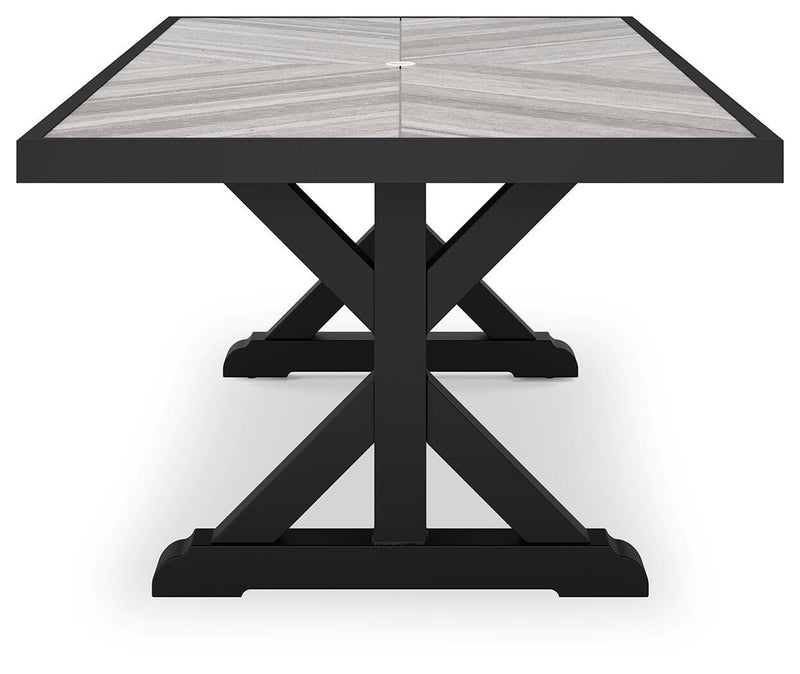 Ashley Furniture Beachcroft outdoor dining table with a wooden top and metal legs, ideal for patio or garden dining spaces.