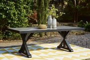 Outdoor Ashley Furniture Beachcroft outdoor dining table with slatted top and sturdy metal frame, ideal for patio or backyard dining.