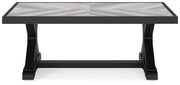 Outdoor Ashley Furniture Beachcroft outdoor cocktail coffee table with a slatted top and sturdy frame, ideal for patio lounging.