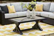 Outdoor Ashley Furniture Beachcroft cocktail table with a metal frame and glass top, ideal for patio or outdoor seating areas.