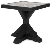 Ashley Furniture Beachcroft outdoor end table shown from an angle, featuring a sturdy wooden design suitable for patio or garden use.