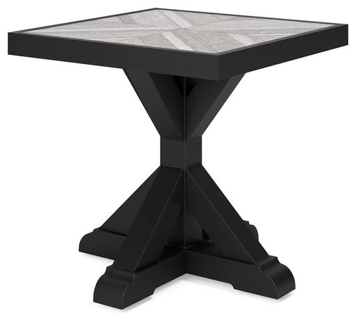 Ashley Furniture Beachcroft outdoor end table shown from an angle, featuring a sturdy wooden design suitable for patio or garden use.