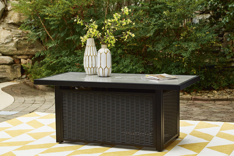 Ashley Furniture Beachcroft outdoor fire pit table with a round metal top and sturdy base for outdoor heating and gatherings.