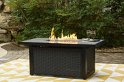 Ashley Furniture Beachcroft outdoor fire pit table with a stone finish and built-in fire bowl for backyard gatherings.