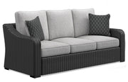 Ashley Furniture Beachcroft outdoor table set with a round table and four chairs, featuring a stylish outdoor design.