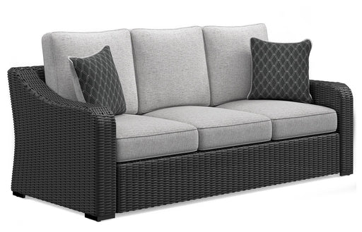 Ashley Furniture Beachcroft outdoor sofa with cushion, showing a stylish outdoor seating area with plush cushions and a sturdy frame.