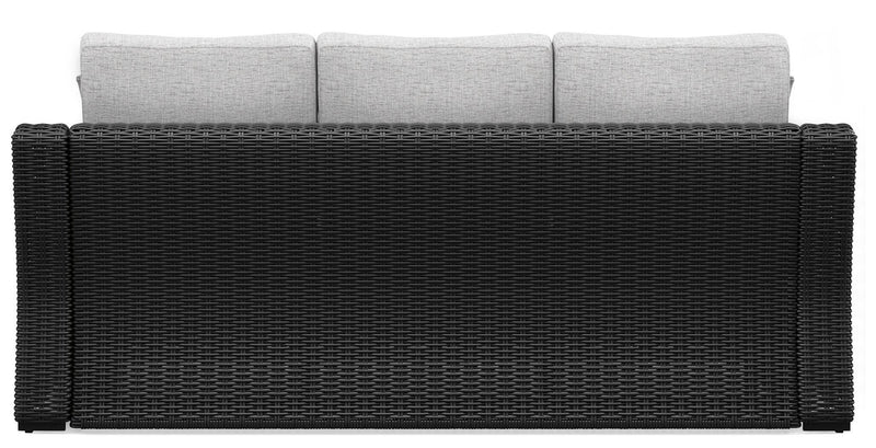 Ashley Furniture Beachcroft outdoor sofa with cushion, showing weather-resistant frame and plush seating for outdoor relaxation.