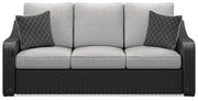 Ashley Furniture Beachcroft outdoor sofa with cushion, showing a stylish patio seating area with comfortable cushions and a modern design.
