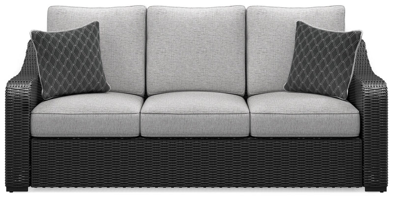 Ashley Furniture Beachcroft outdoor sofa with cushion, showing a stylish patio seating area with comfortable cushions and a modern design.