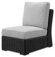 Ashley Furniture Beachcroft outdoor sectional shown from an angled view with plush cushions and stylish wicker frame.