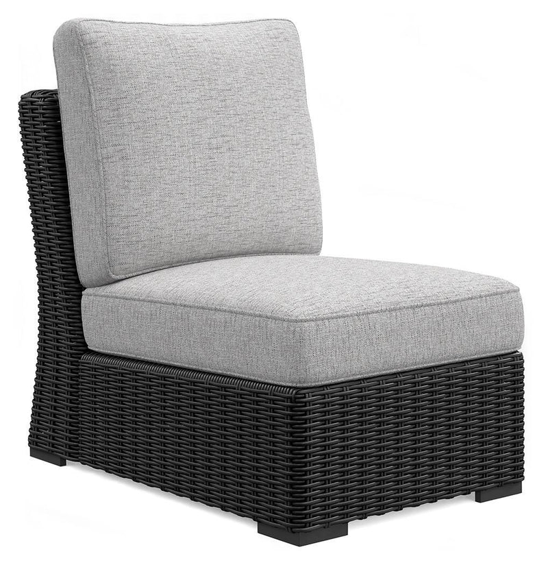 Ashley Furniture Beachcroft outdoor sectional with cushioned seats and wicker frame, shown in an angled view.