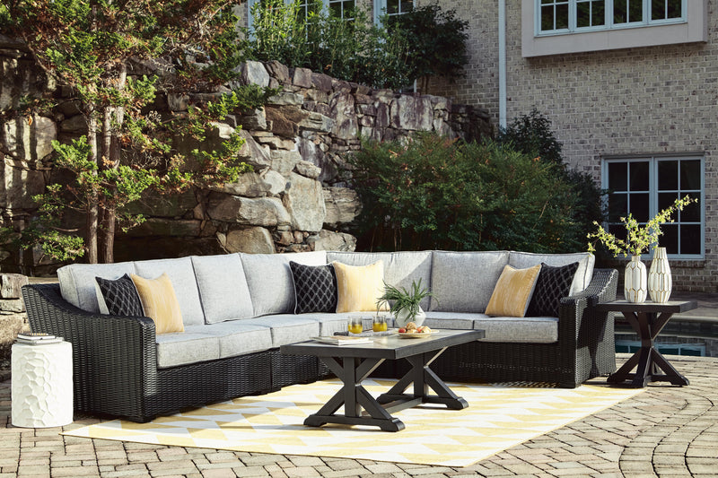 Ashley Furniture Beachcroft outdoor end table with a woven design and sturdy wooden frame for patio or garden use.