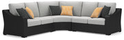 Ashley Furniture Beachcroft outdoor sectional with plush cushions, shown from an angled view on a patio setting.
