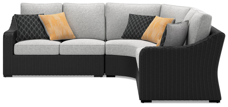 Ashley Furniture Beachcroft outdoor sectional with beige cushions and woven rattan frame, designed for comfortable outdoor lounging.