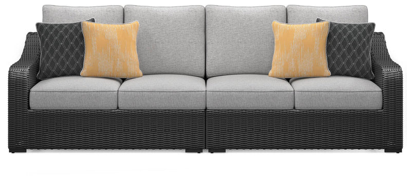 Ashley Furniture Beachcroft 2-piece outdoor loveseat sectional with cushions, featuring plush seating and stylish design.