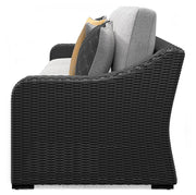 Outdoor sectional loveseat with cushions from Ashley Furniture, featuring beige fabric and a modern design for patio relaxation.