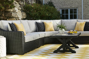 Ashley Furniture Beachcroft outdoor cocktail table with a modern design, featuring a sturdy wooden top and metal frame.