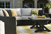 Ashley Furniture Beachcroft outdoor cocktail table with a textured surface and metal frame, perfect for patio or garden use.