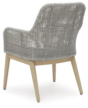 Seton Creek outdoor seating set by Ashley Furniture with cushioned chairs and a matching table, perfect for patio relaxation.