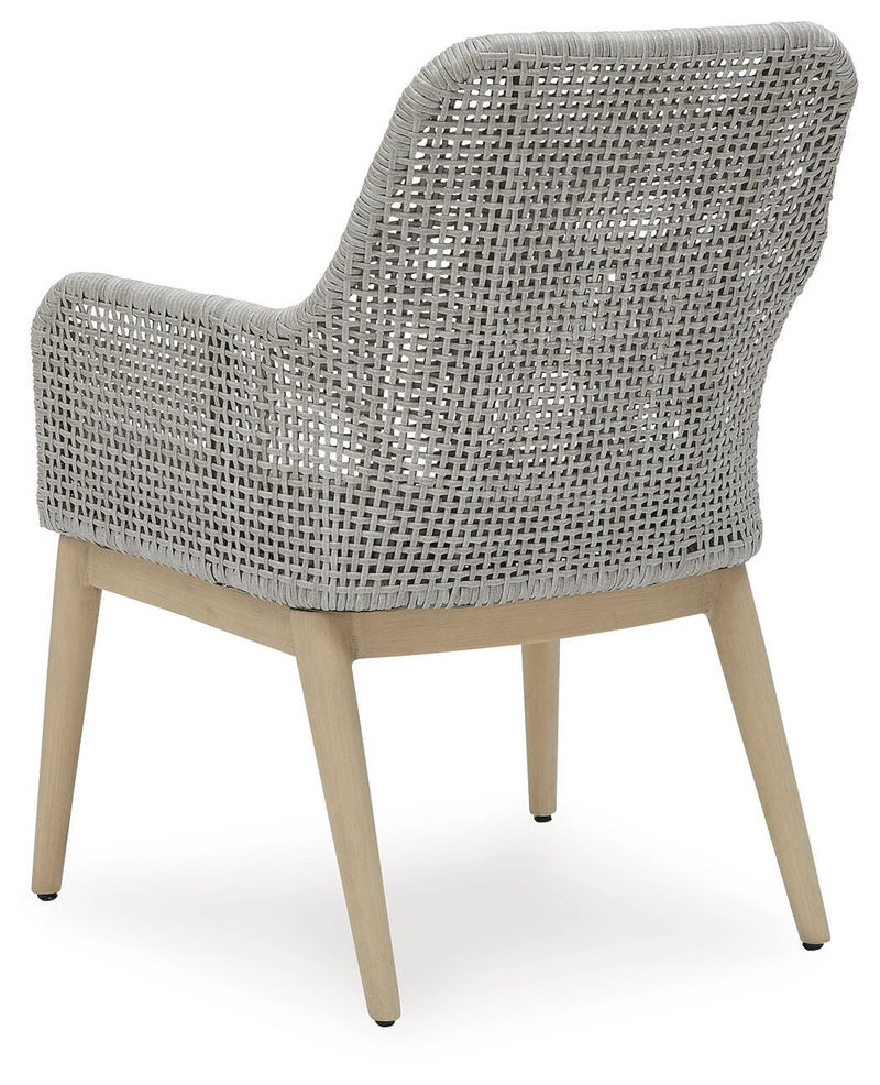 Seton Creek outdoor seating set by Ashley Furniture with cushioned chairs and a matching table, perfect for patio relaxation.