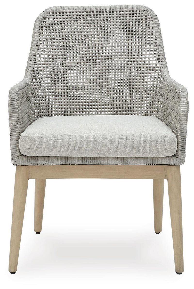 Ashley Furniture Seton Creek outdoor seating set with cushioned chairs and a matching table, ideal for patio relaxation.