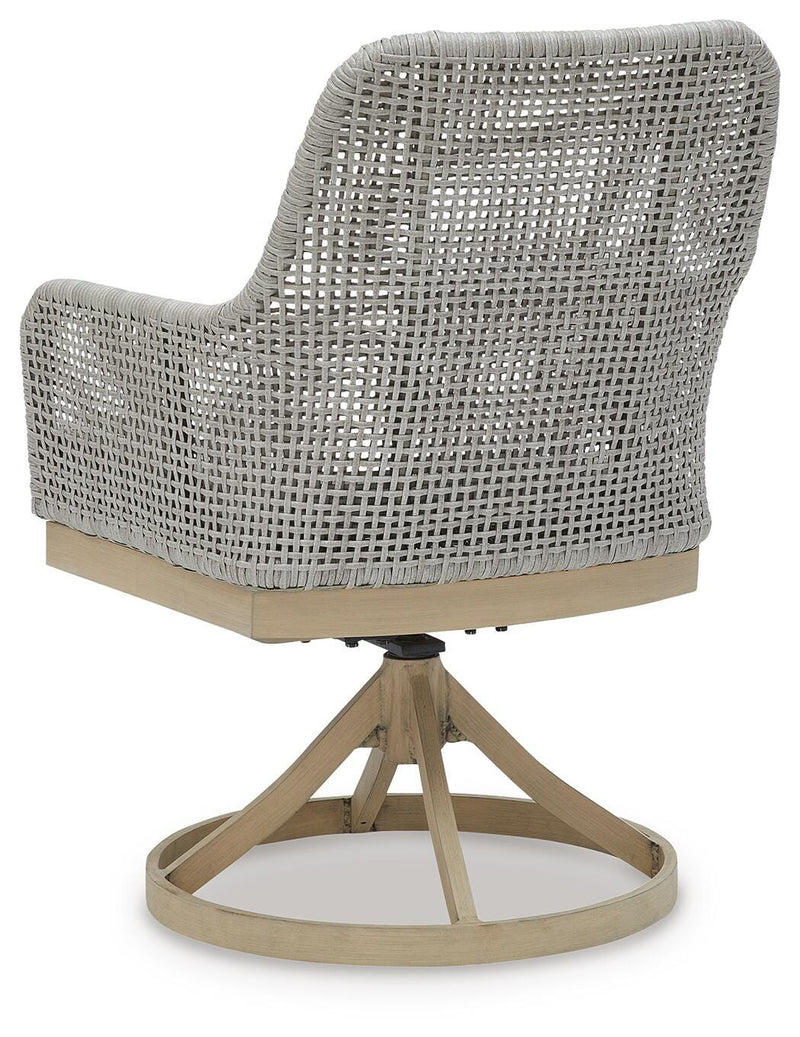 Outdoor Seton Creek outdoor seating set by Ashley Furniture with cushioned chairs and a matching table in a garden setting.