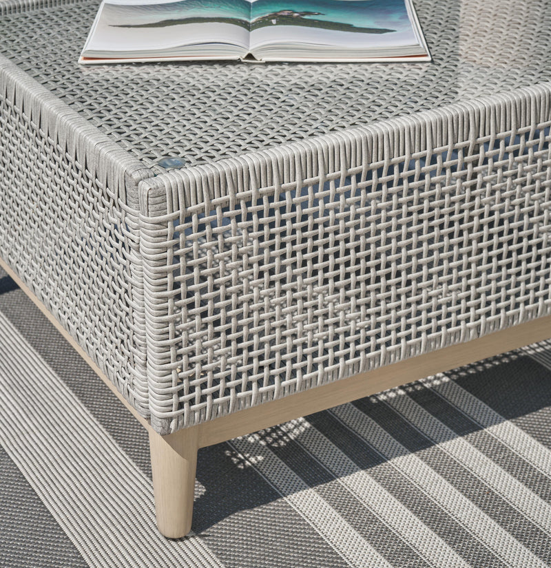 Seton Creek outdoor upholstery table set by Ashley Furniture, featuring a stylish outdoor table and matching cushioned chairs.