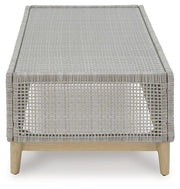 Ashley Furniture Seton Creek outdoor upholstery set with a table and chairs, featuring weather-resistant cushions and stylish design.